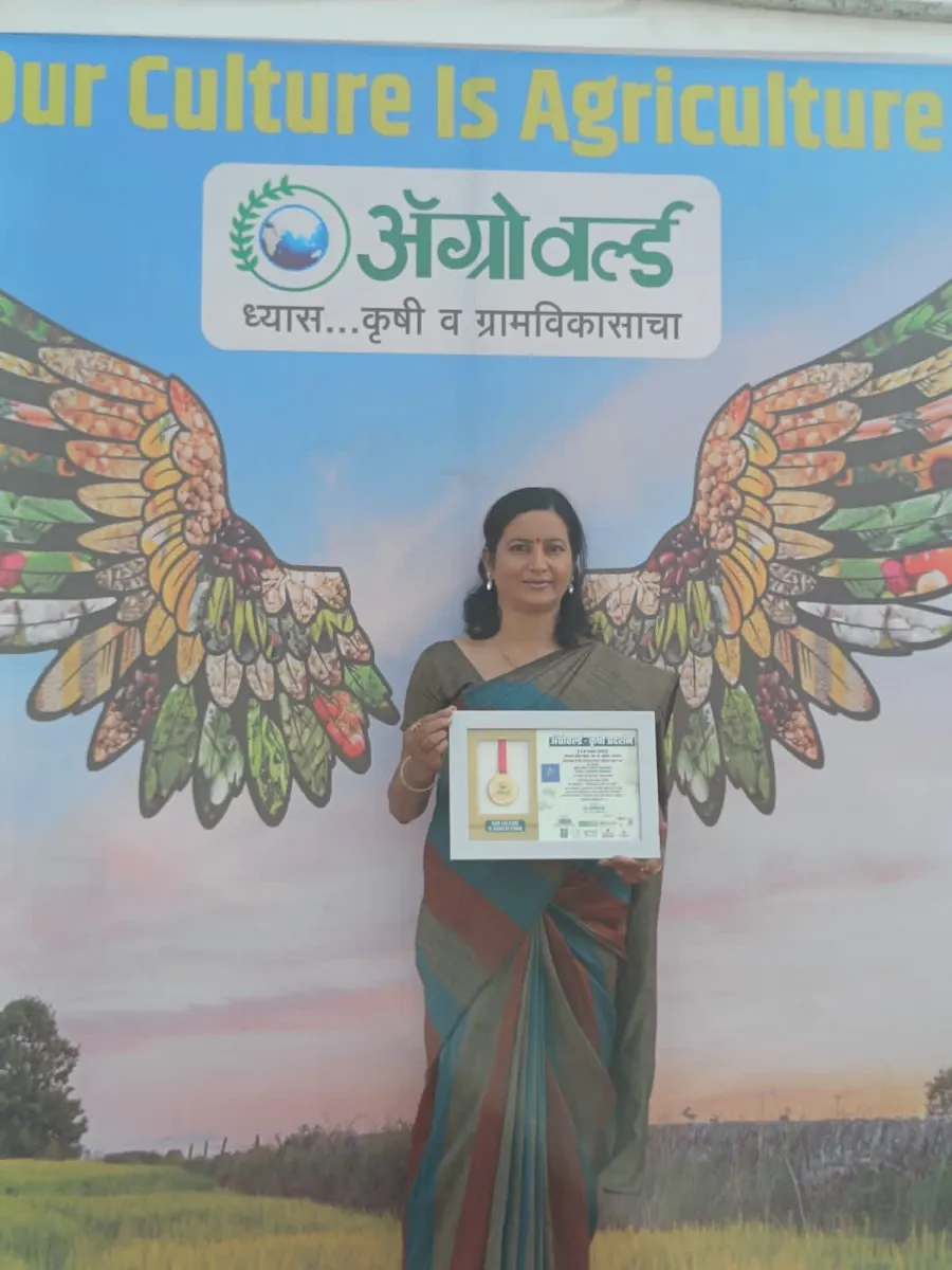 Founder receiving the Agroworld Award 2024 on stage in front of the Agroworld backdrop