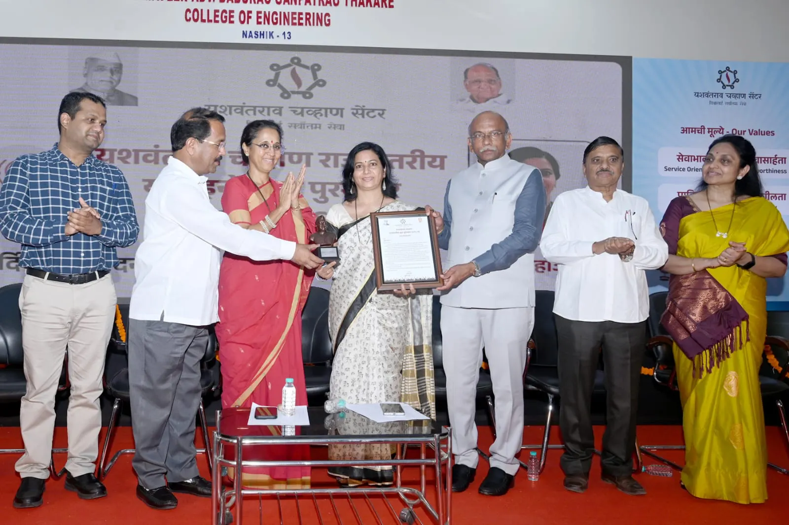 Founder being presented the Yashwantrao Chavan State Level Yuva Puraskar 2025-26 on stage by dignitaries including MP Supriya Sule